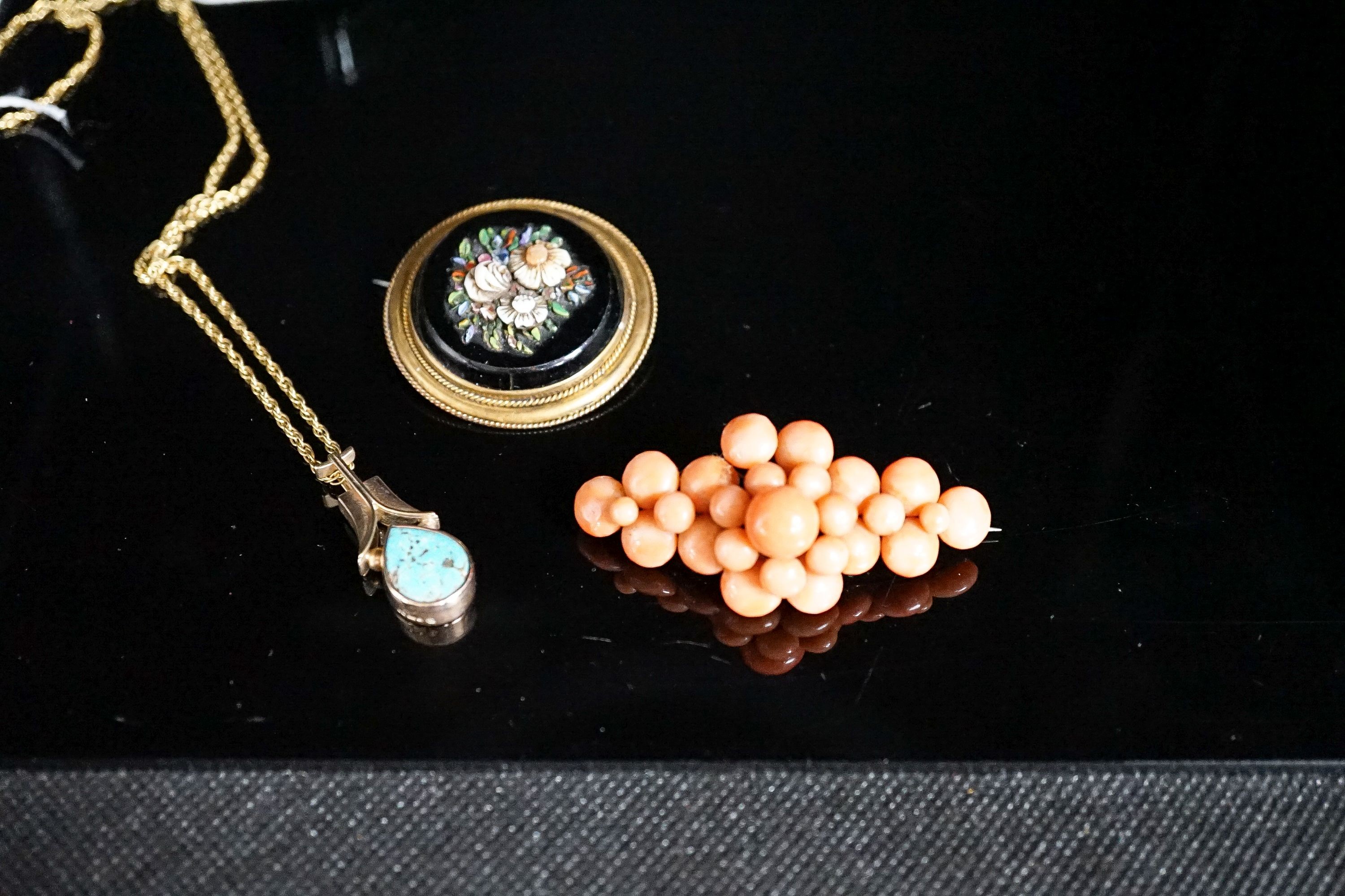 A Victorian yellow metal, black onyx and hardstone set circular brooch, 38mm, a yellow metal and coral bead brooch and a yellow metal and turquoise set pendant, on a 375 chain.